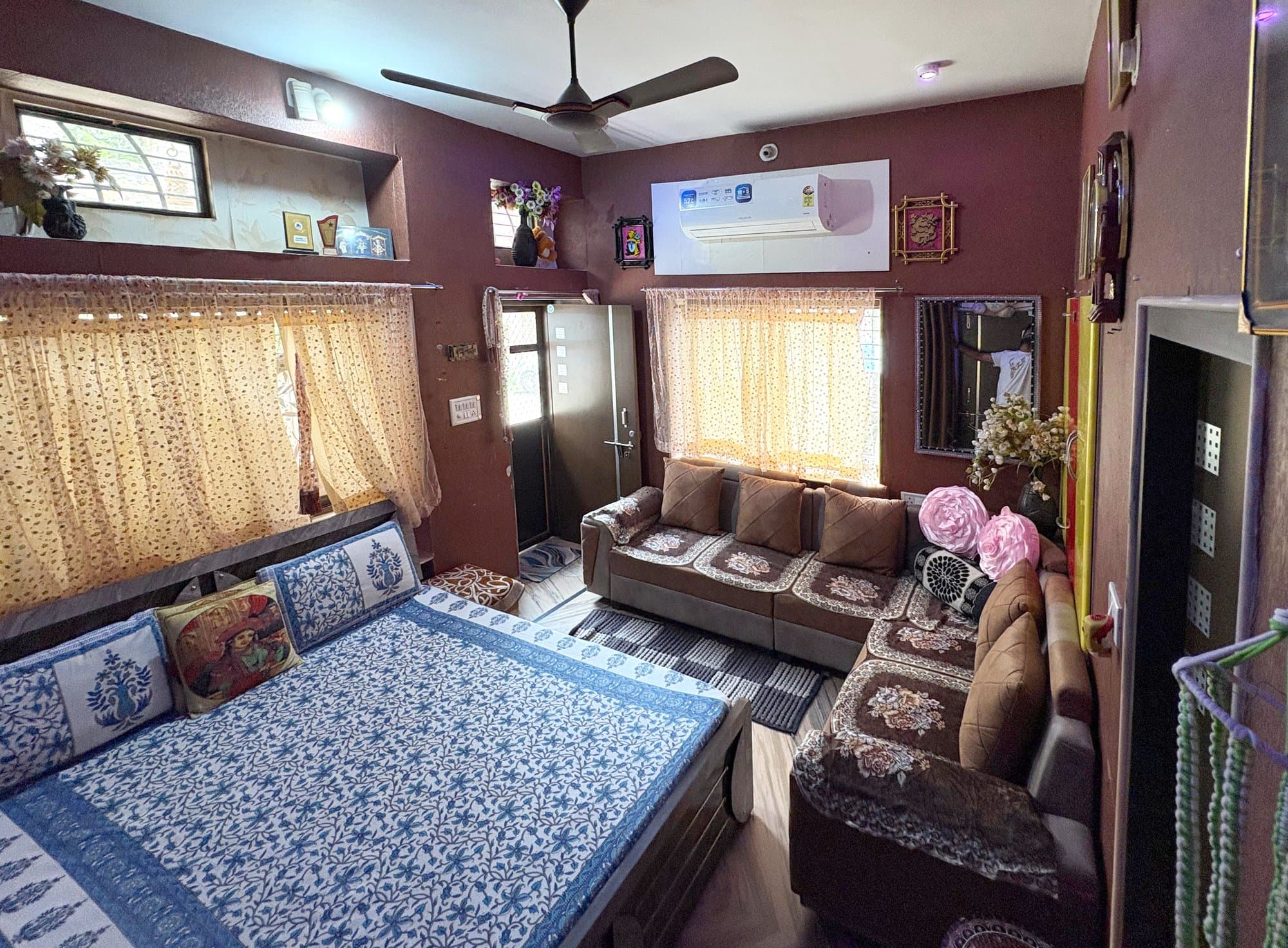 Deluxe AC room with comfortable bedding at Shri Radha Home Stay